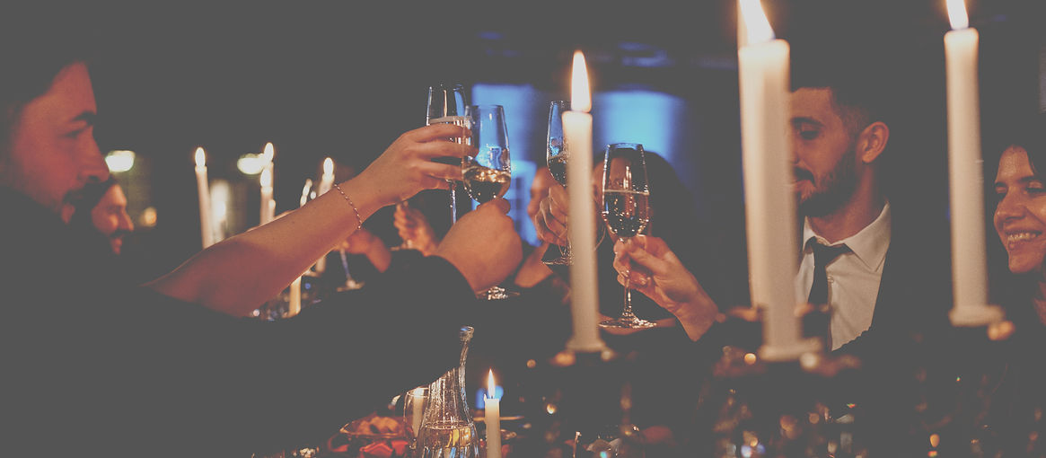 Guests toasting with champagne beside candlelight at a Chateau de Lis corporate dinner