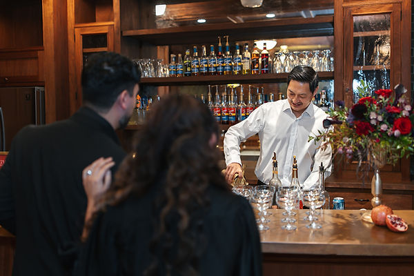 Bartender preparing drinks at the Chateau de Lis bar for a multi-day event