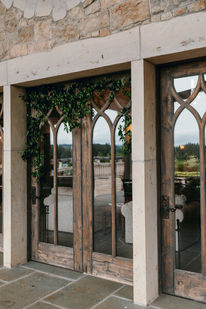 Gothic arched windows of the chateau draped in trailing greenery