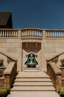 Ornate stone staircase and balustrade leading up to a courtyard fountain